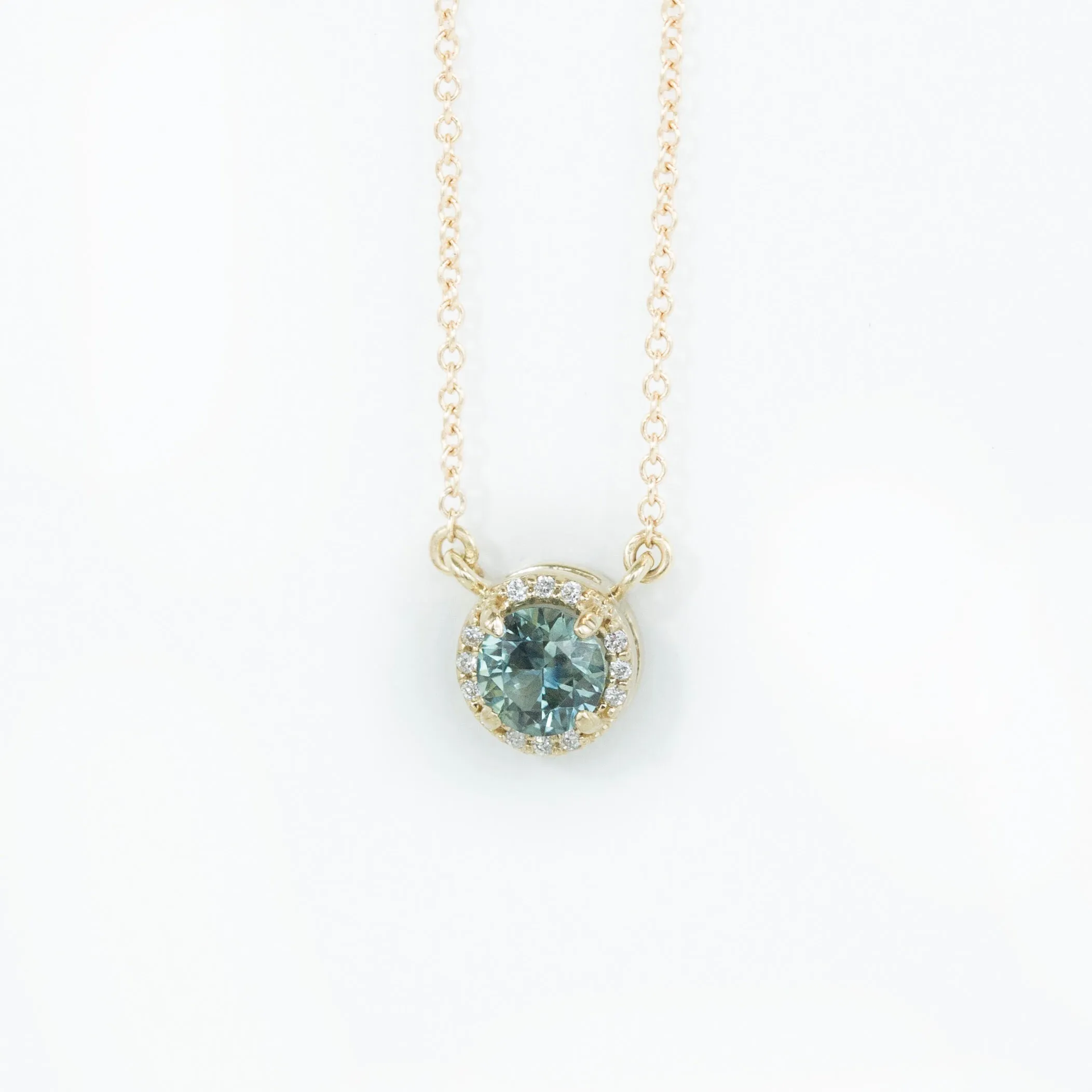 Madagascar Sapphire and diamond halo necklace in 14k gold